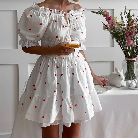 European and American style off-the-shoulder dress with heart print, white fabric, short length, street fashion.