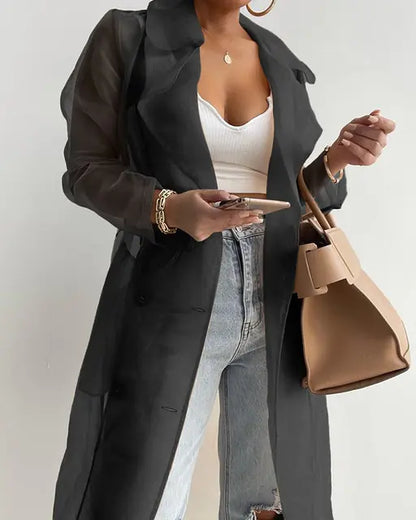 Women fashion see-through outdoor top with sheer mesh design and long sleeves.