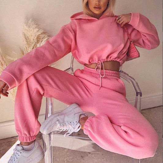 Women's pink 2-piece jogging suit with long sleeve hoodie and jogger pants, perfect for casual fitness wear.